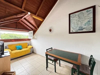 Living room; tile floor, natural light, wood beams