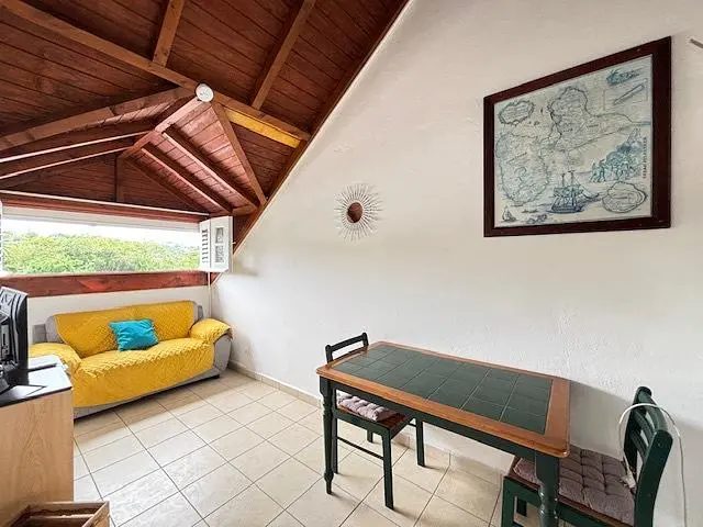 Living room; tile floor, natural light, wood beams