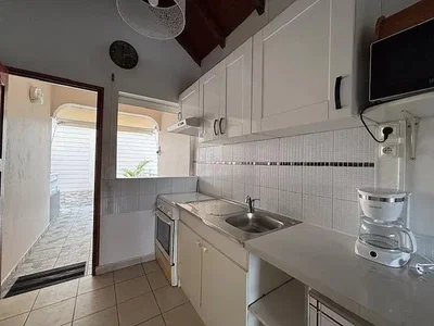 Kitchen; kitchen appliances, tile floor, natural light