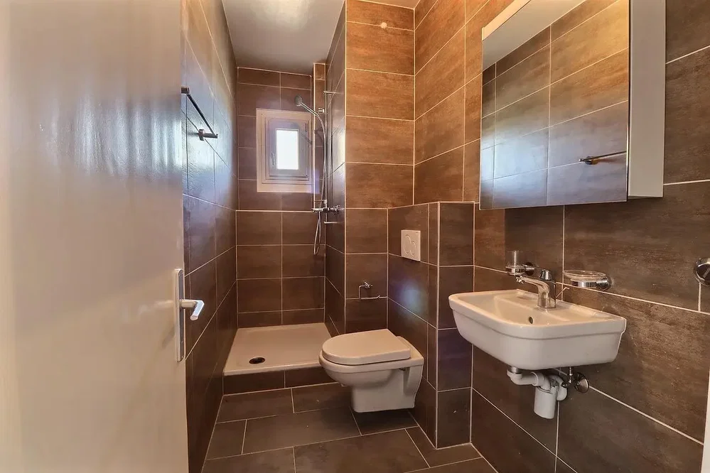 Toilet; tile floor, renovated, natural light