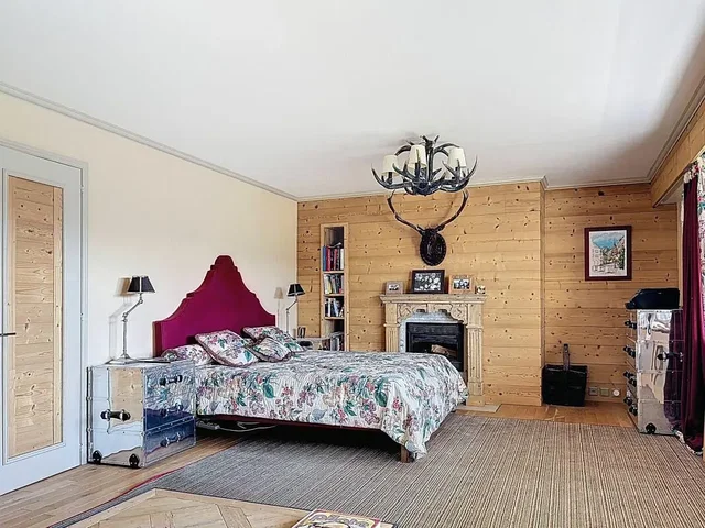 Bedroom; wood beams, fireplace, wood floor, natural light