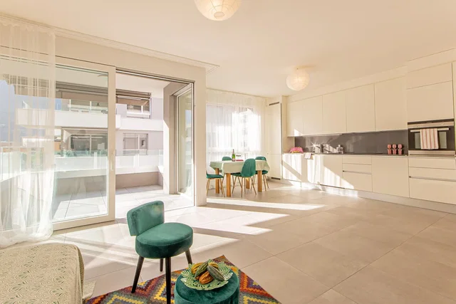Living room; natural light, tile floor, kitchen appliances