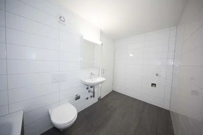 Toilet; tile floor, natural light