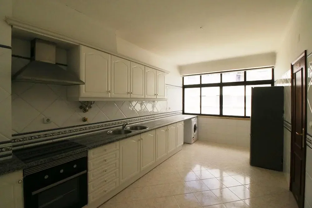 Kitchen; kitchen appliances, tile floor, natural light
