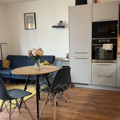 Living room; kitchen appliances, wood floor, natural light