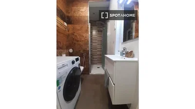 Bagno; pavimento in piastrelle, travi in legno, luce naturale