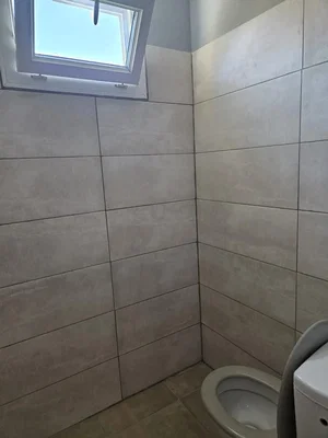 Toilet; tile floor, natural light