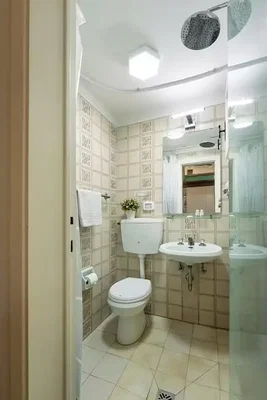 Toilet; tile floor, natural light