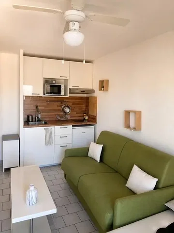 Living room; kitchen appliances, tile floor, natural light