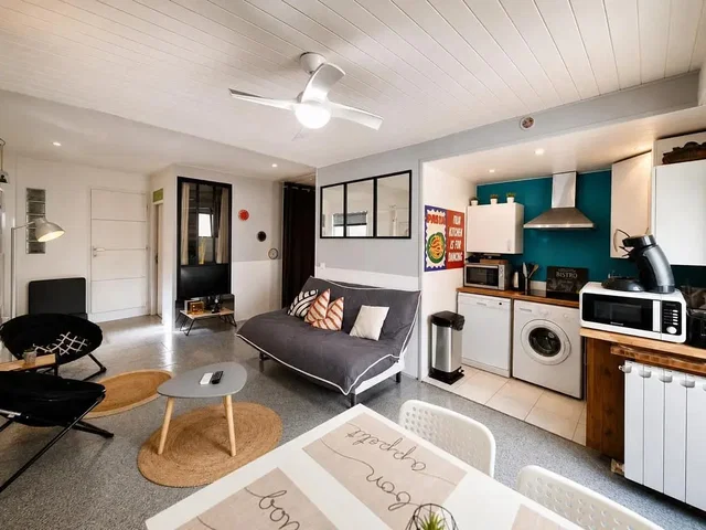 Living room; natural light, tile floor, kitchen appliances