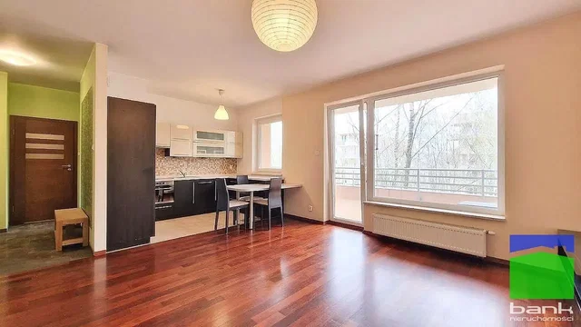 Living room; wood floor, natural light, kitchen appliances