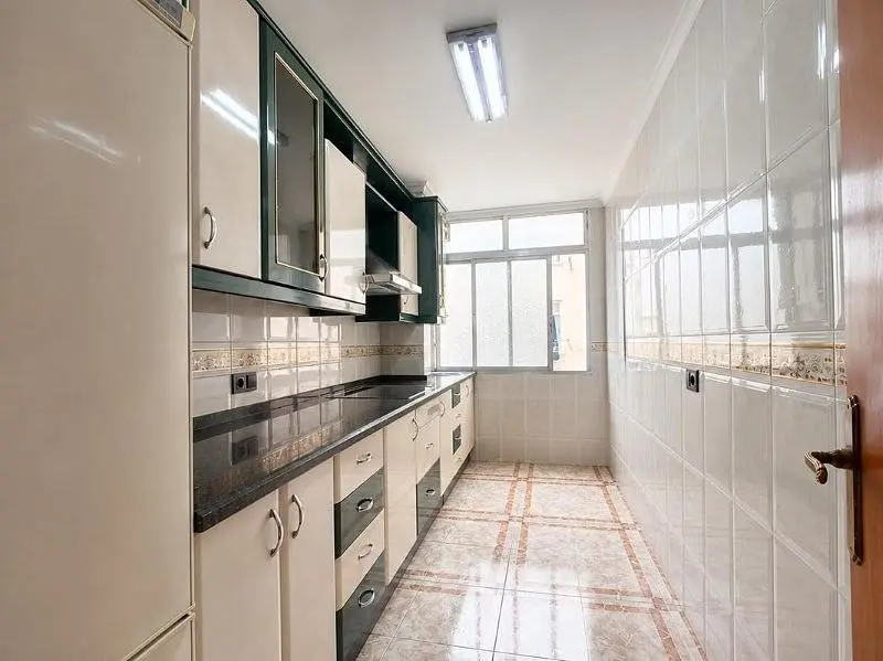 Kitchen; kitchen appliances, tile floor, natural light