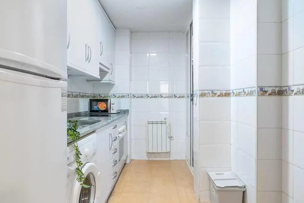 Kitchen; kitchen appliances, tile floor, natural light