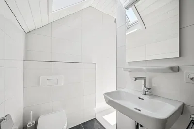 Toilet; tile floor, natural light