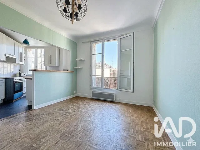 Living room; kitchen appliances, natural light, wood floor