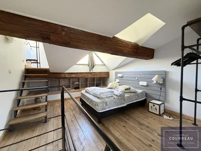 Bedroom; wood beams, wood floor, natural light