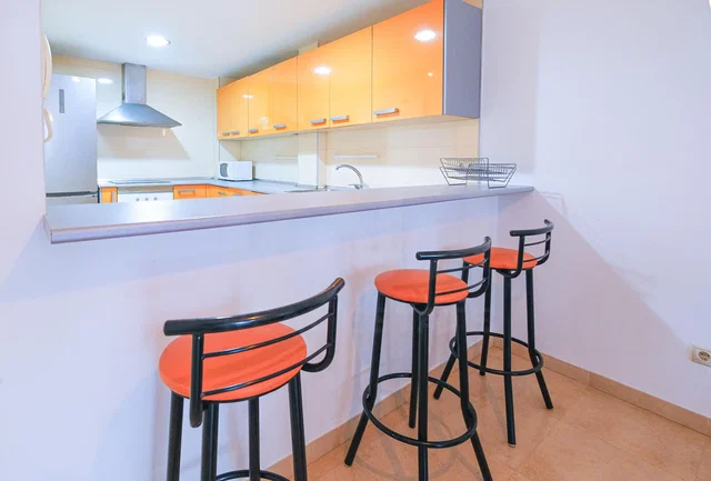Kitchen; kitchen appliances, natural light, tile floor
