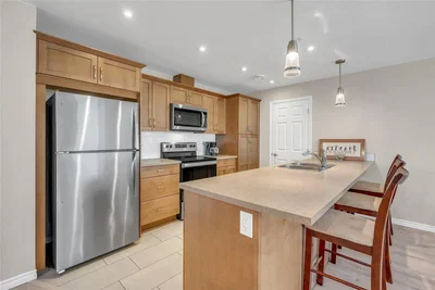 Kitchen; kitchen appliances, wood floor, natural light, modern style, renovated