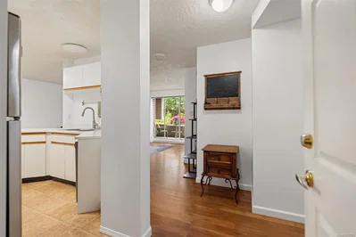 Kitchen; kitchen appliances, tile floor, wood floor, natural light