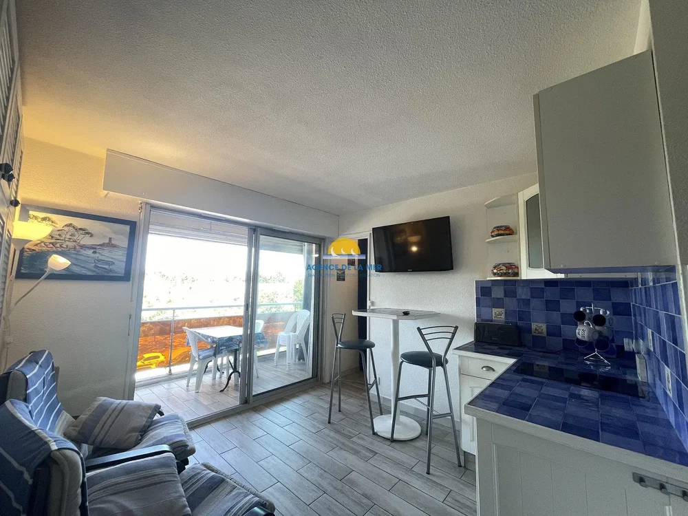 Living room; kitchen appliances, natural light, tile floor