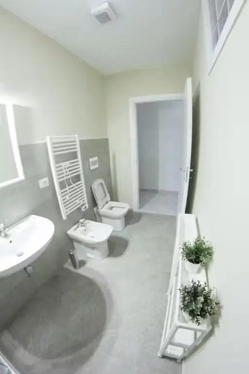 Toilet; tile floor, natural light