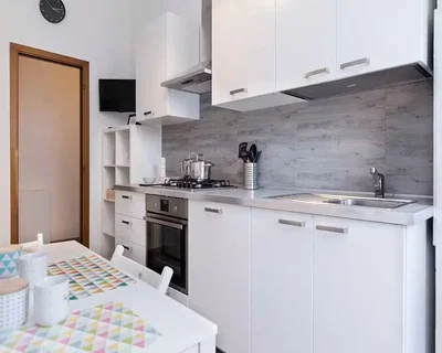 Kitchen; kitchen appliances, tile floor, natural light