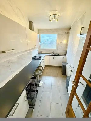 Kitchen; kitchen appliances, tile floor, natural light