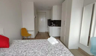 Bedroom; kitchen appliances, wood floor, natural light