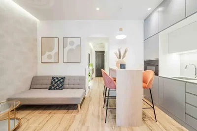 Living room; wood floor, kitchen appliances, natural light, modern style, renovated
