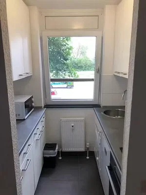 Kitchen; kitchen appliances, tile floor, natural light