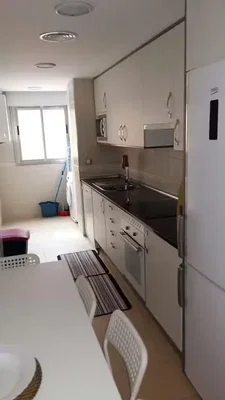 Kitchen; kitchen appliances, natural light, tile floor