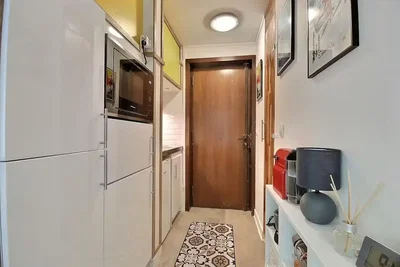 Kitchen; kitchen appliances, tile floor, natural light