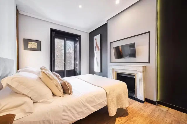 Bedroom; wood floor, fireplace, natural light