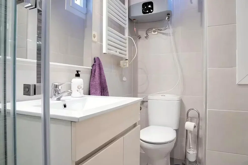 Toilet; tile floor, renovated, natural light