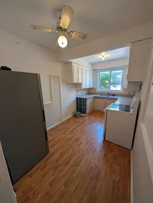 Kitchen; wood floor, natural light, needs renovation