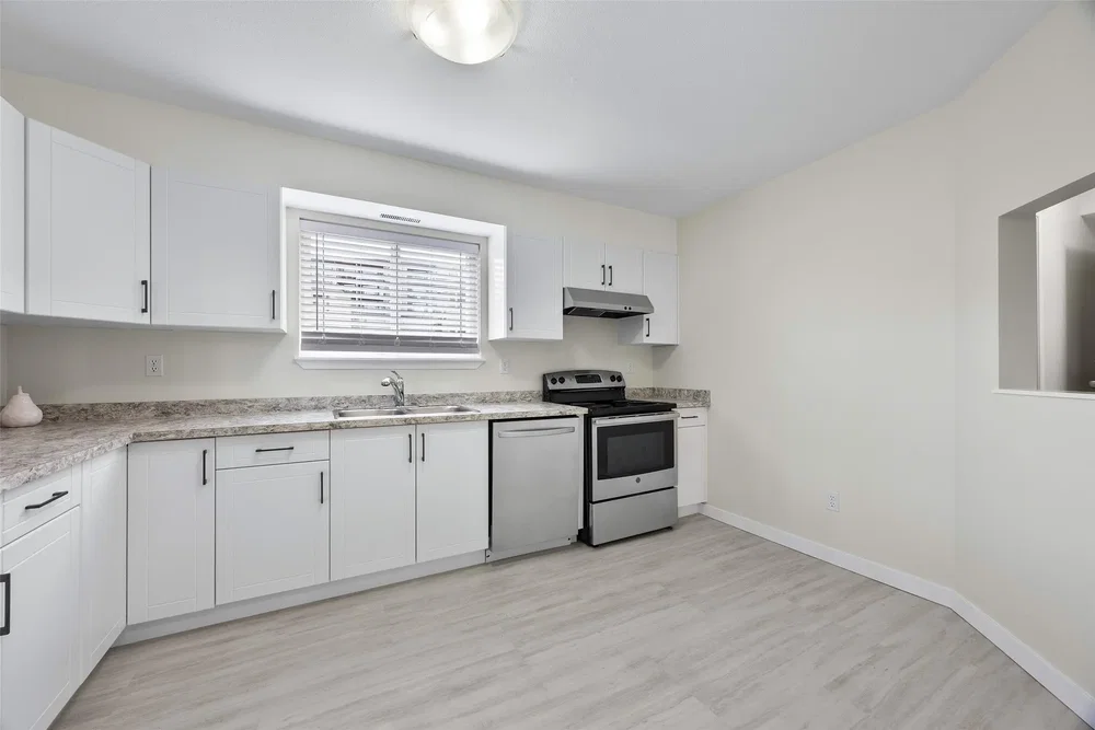 Kitchen; kitchen appliances, tile floor, natural light, modern style, renovated