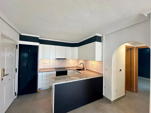 Kitchen; kitchen appliances, tile floor, natural light
