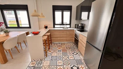 Kitchen; kitchen appliances, tile floor, natural light