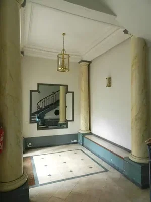 Living room; high ceiling, natural light, tile floor