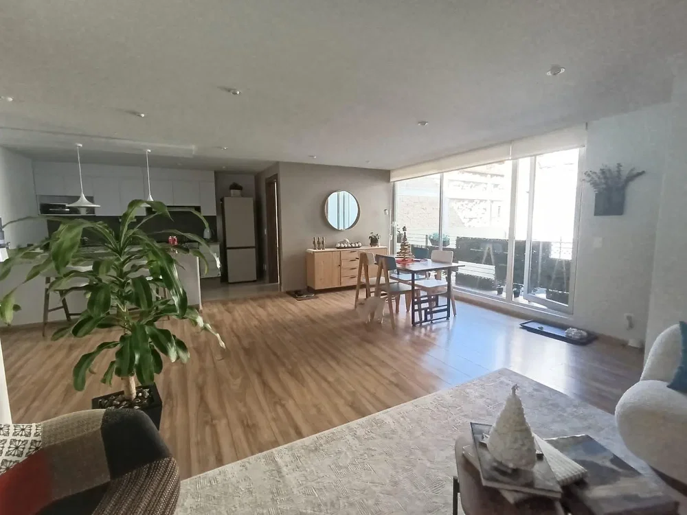 Living room; natural light, wood floor, kitchen appliances