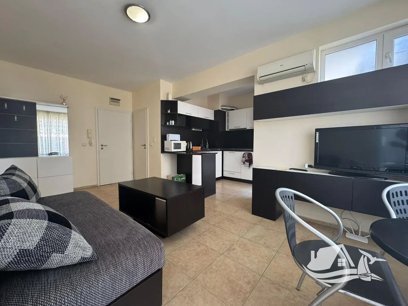 Living room; kitchen appliances, tile floor, natural light