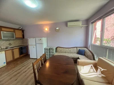 Living room; kitchen appliances, wood floor, natural light
