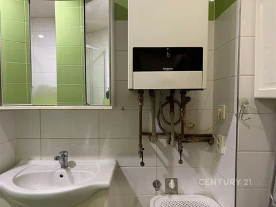 Toilet; water heater, tile floor, needs renovation