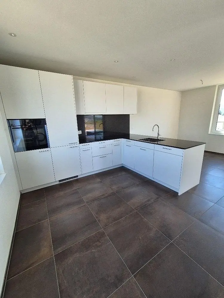 Kitchen; kitchen appliances, tile floor, natural light, renovated