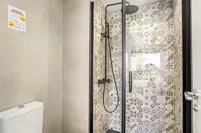 Toilet; tile floor, natural light, renovated