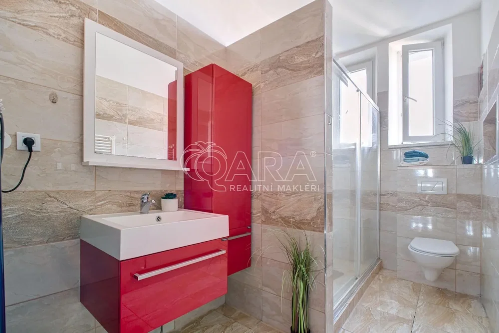 Toilet; tile floor, renovated, natural light