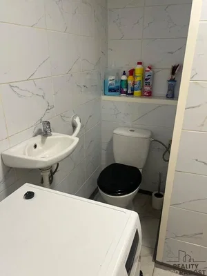 Toilet; tile floor, needs renovation