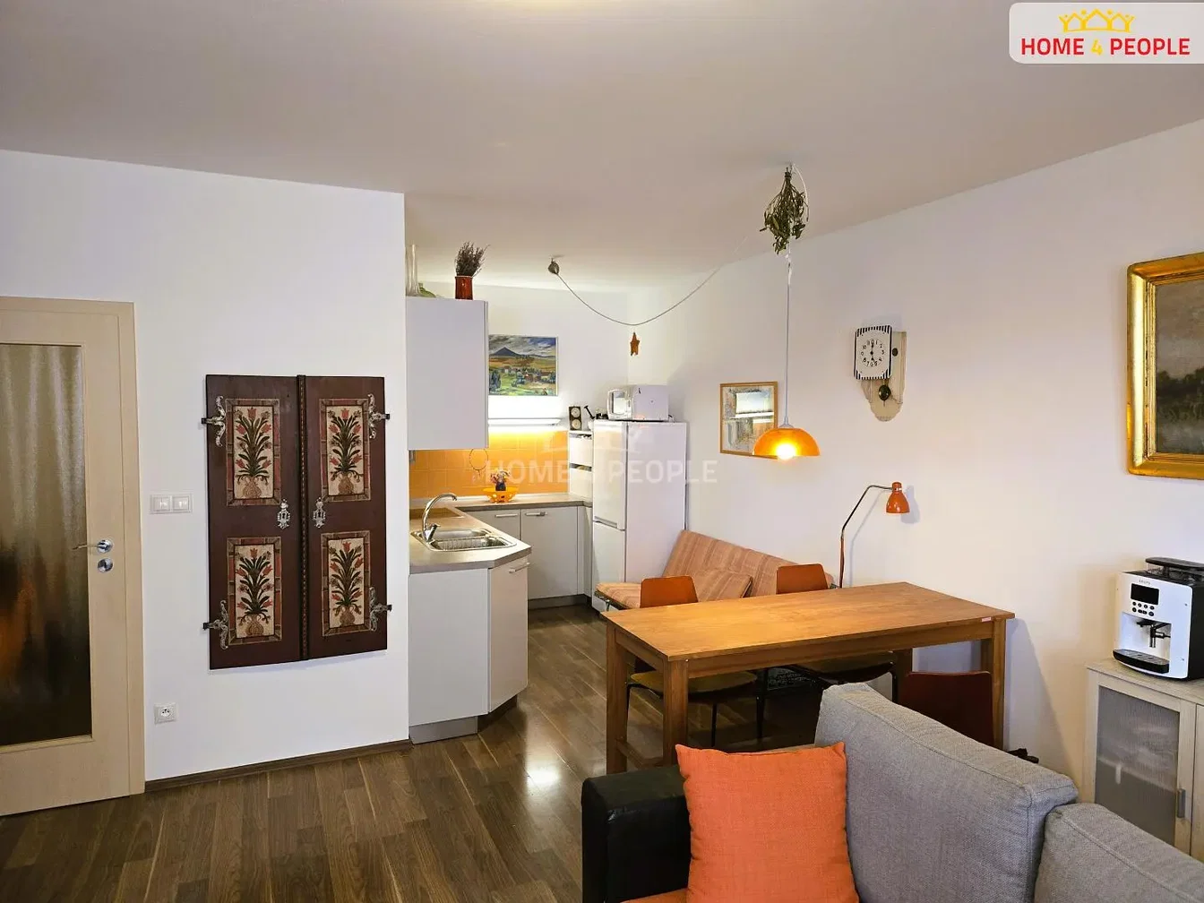Living room; kitchen appliances, wood floor, natural light