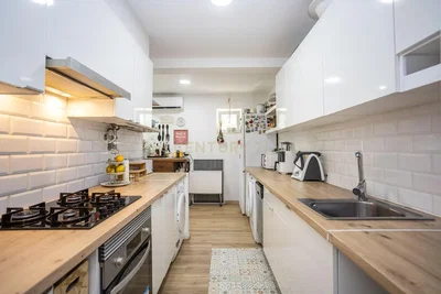 Kitchen; kitchen appliances, wood floor, tile floor, natural light, modern style, renovated
