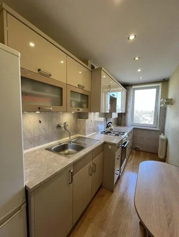 Kitchen; kitchen appliances, tile floor, wood floor, natural light
